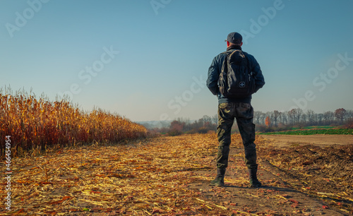 a man standing in a mowed field