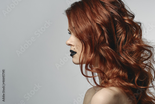 red-haired woman with bare shoulders bright makeup base zodiac sign horoscope