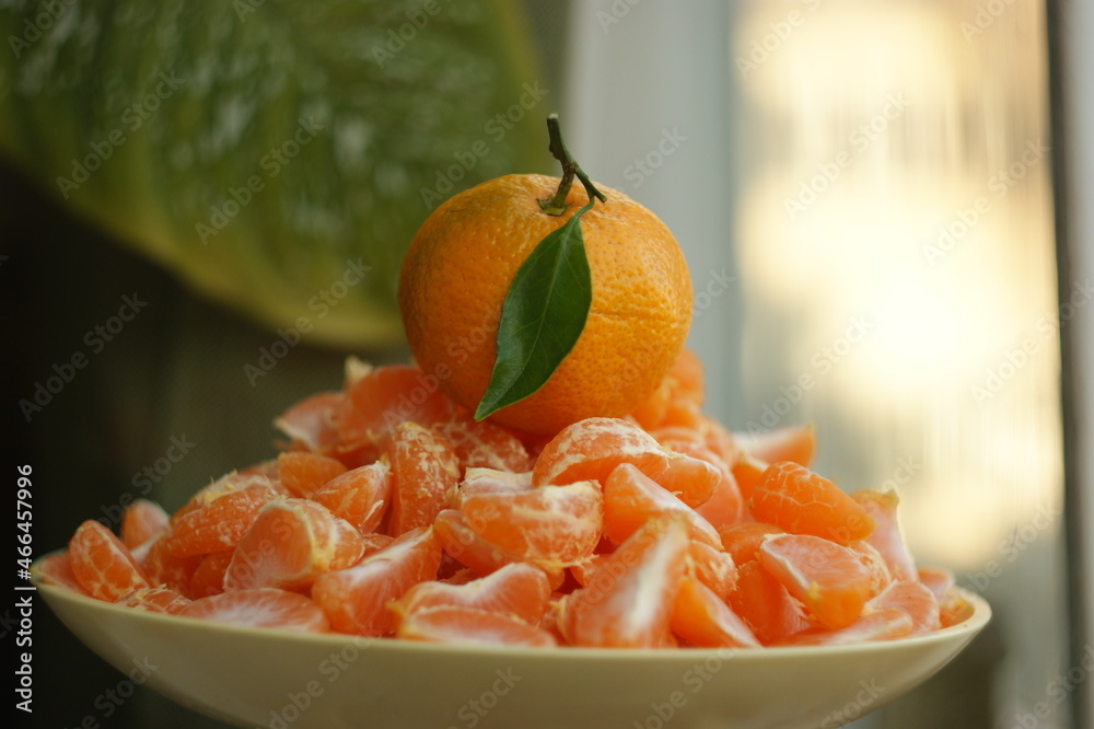 ripe and juicy tangerine (mandarin). fresh tangerine with leaf on white, closeup ripe and juicy tangerine (mandarin). fresh tangerine with leaf on white, closeup
