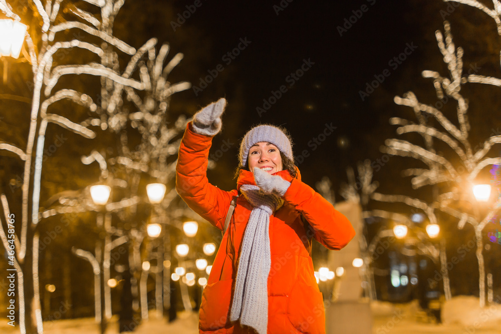 Young pretty funny girl having fun outdoor in winter. Christmas, city and winter holidays concept.