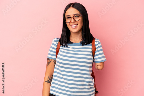 Print op canvas Young caucasian student woman with one arm isolated on pink background happy, smiling and cheerful