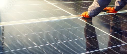 Quadro su tela Close-up of hands worker installing solar cell farm power plant eco technology