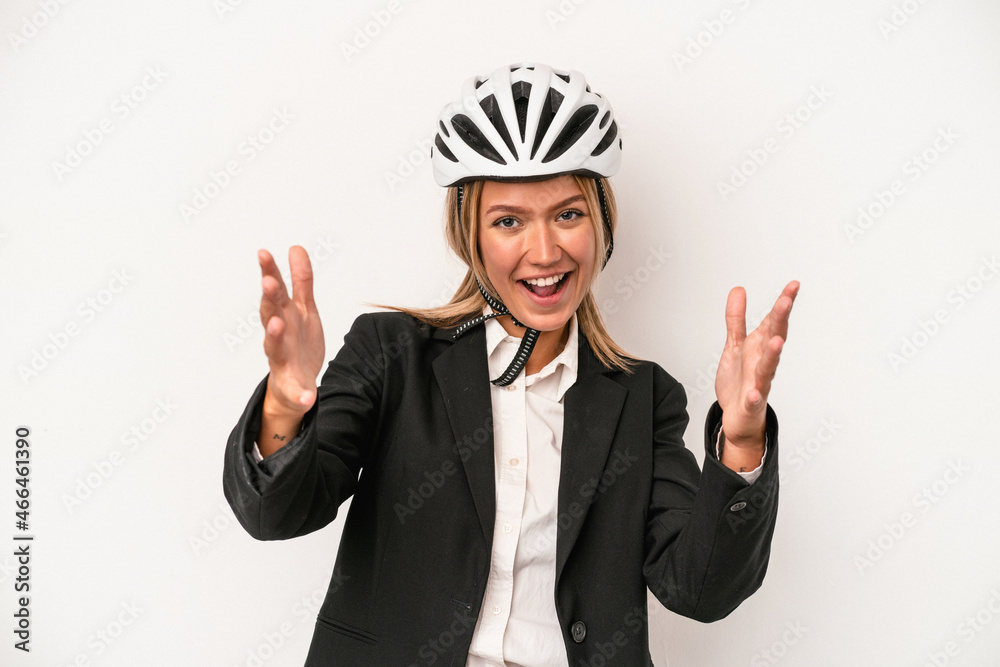 Young caucasian business woman wearing a bike helmet isolated on white background receiving a pleasant surprise, excited and raising hands. Young caucasian business woman wearing a bike helmet isolated on white background receiving a pleasant surprise, excited and raising hands.