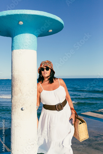 attractive woman with hat wicker bag and sunglasses l