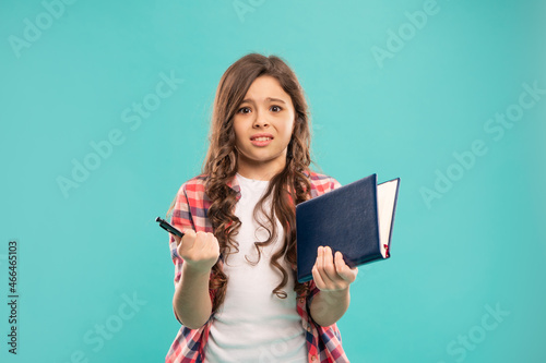 confused kid hold notebook on blue background, childhood