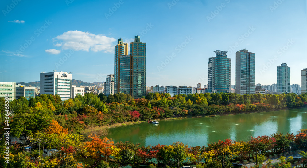 Seokchon lake and surrounding buildings with autumn colors, Jamsil, Songpa-gu, Seoul, South Korea.