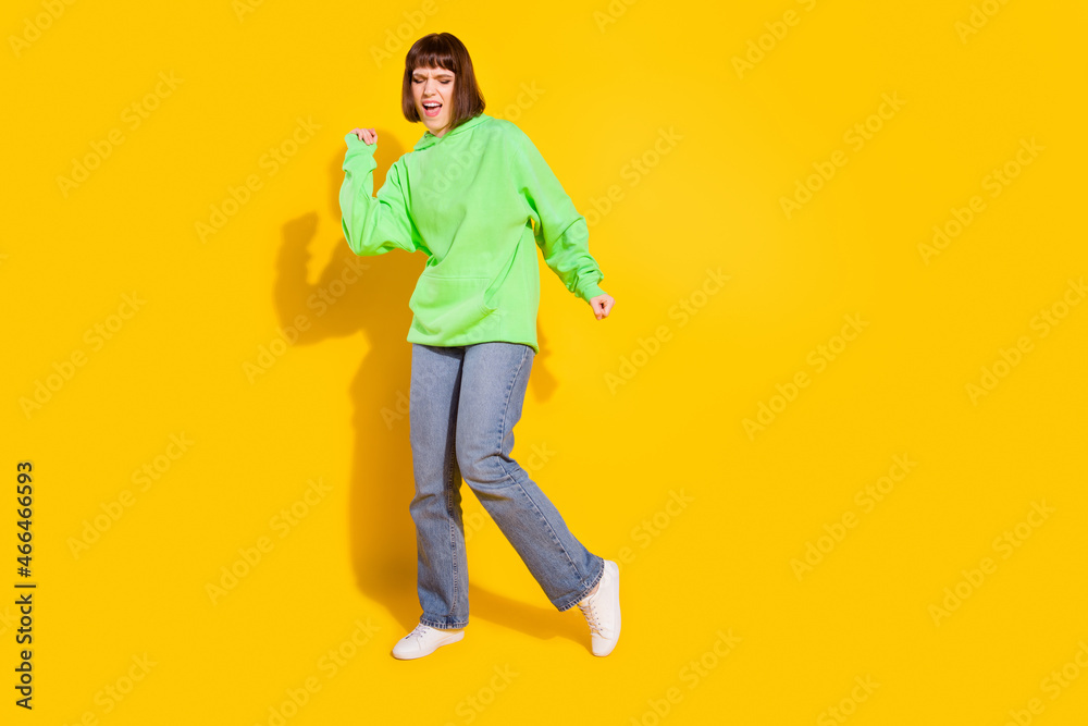 Full length body size view of attractive girl dancing having fun good mood isolated over bright yellow color background Full length body size view of attractive girl dancing having fun good mood isolated over bright yellow color background