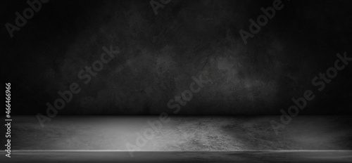 Black table top empty space display in the dark textured background.