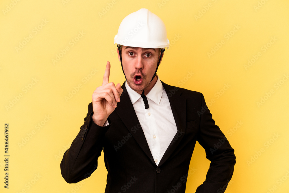Young architect caucasian man isolated on yellow background having an idea, inspiration concept. Young architect caucasian man isolated on yellow background having an idea, inspiration concept.