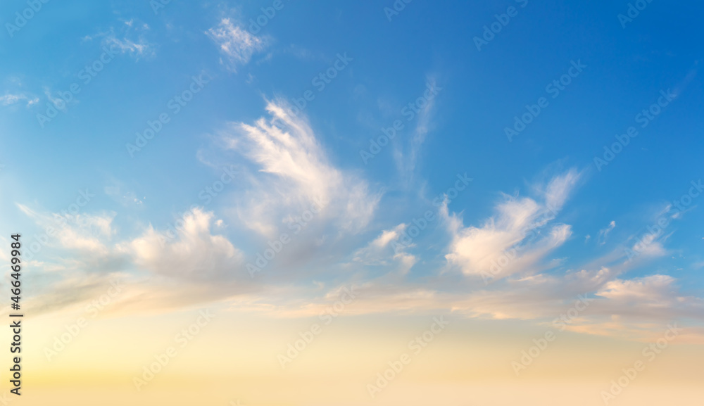 Light cirrus clouds in the blue sky during dawn sunset