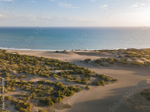 Landscape of the Dunes of Bani surrounded by the sea under the sunlight in the Dominican Republic photo
