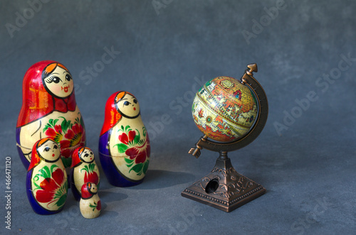 matroshka, dolls forming a family looking at the globe photo