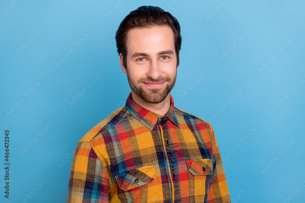 Photo of sweet shiny young guy dressed checkered shirt smiling isolated blue color background Photo of sweet shiny young guy dressed checkered shirt smiling isolated blue color background