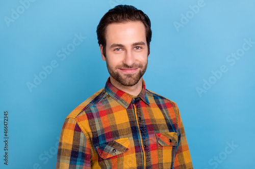 Photo of sweet shiny young guy dressed checkered shirt smiling isolated blue color background