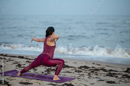 woman doing yoga exercise on beach, balance, fitness, stretching and relaxation	