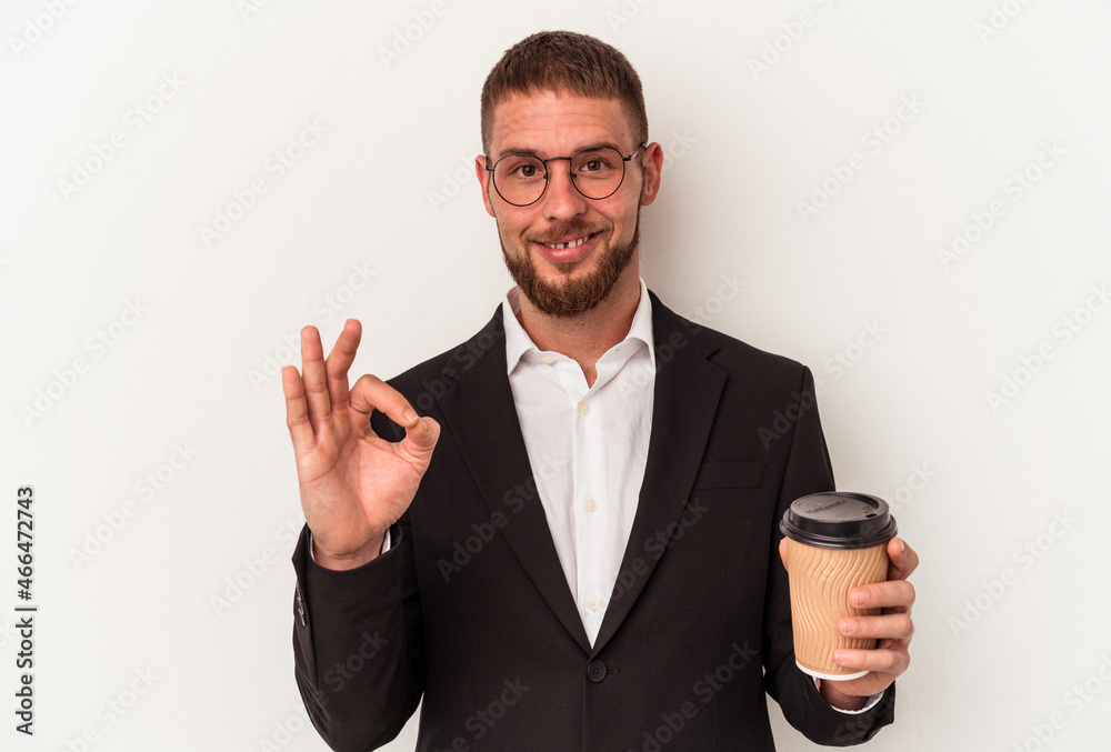 Young business caucasian man holding take away coffee isolated on white background cheerful and confident showing ok gesture. Young business caucasian man holding take away coffee isolated on white background cheerful and confident showing ok gesture.