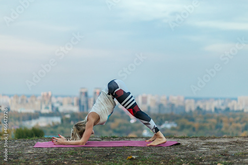 woman doing stretching exercise in the park, balance, fitness, stretching and relaxation	