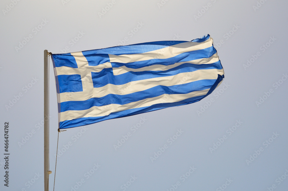 Obraz premium Sunlit Greek flag waving in the wind