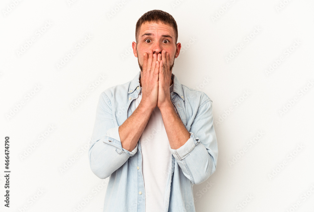 Young caucasian man with diastema isolated on white background covering mouth with hands looking worried. Young caucasian man with diastema isolated on white background covering mouth with hands looking worried.