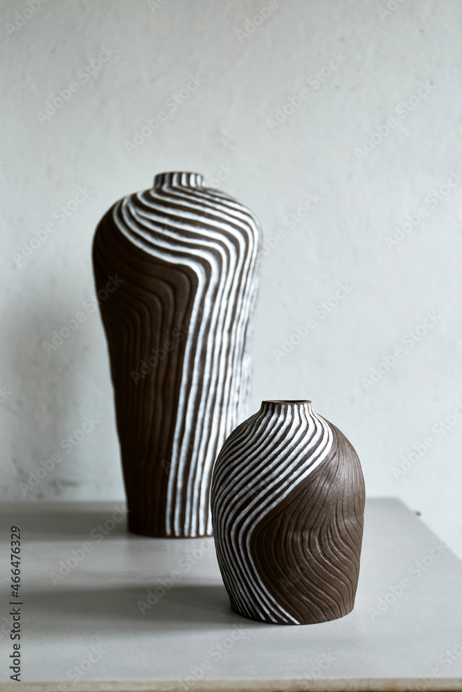 Handmade ceramic vase standing on grey table on light background. Art of  clay. The process of creating pottery Photos | Adobe Stock