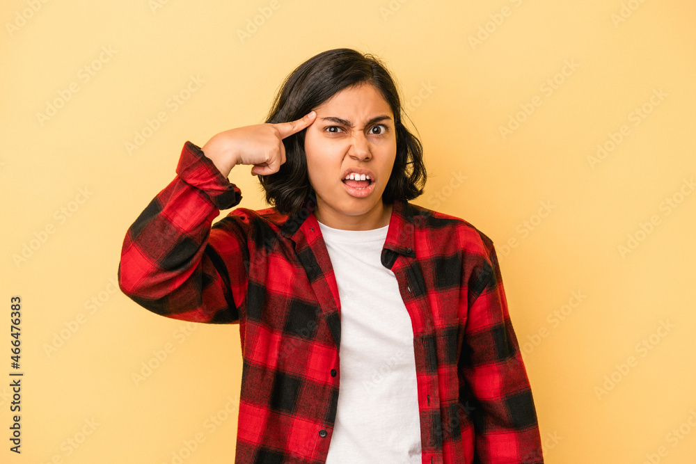 Young latin woman isolated on yellow background showing a disappointment gesture with forefinger. Young latin woman isolated on yellow background showing a disappointment gesture with forefinger.