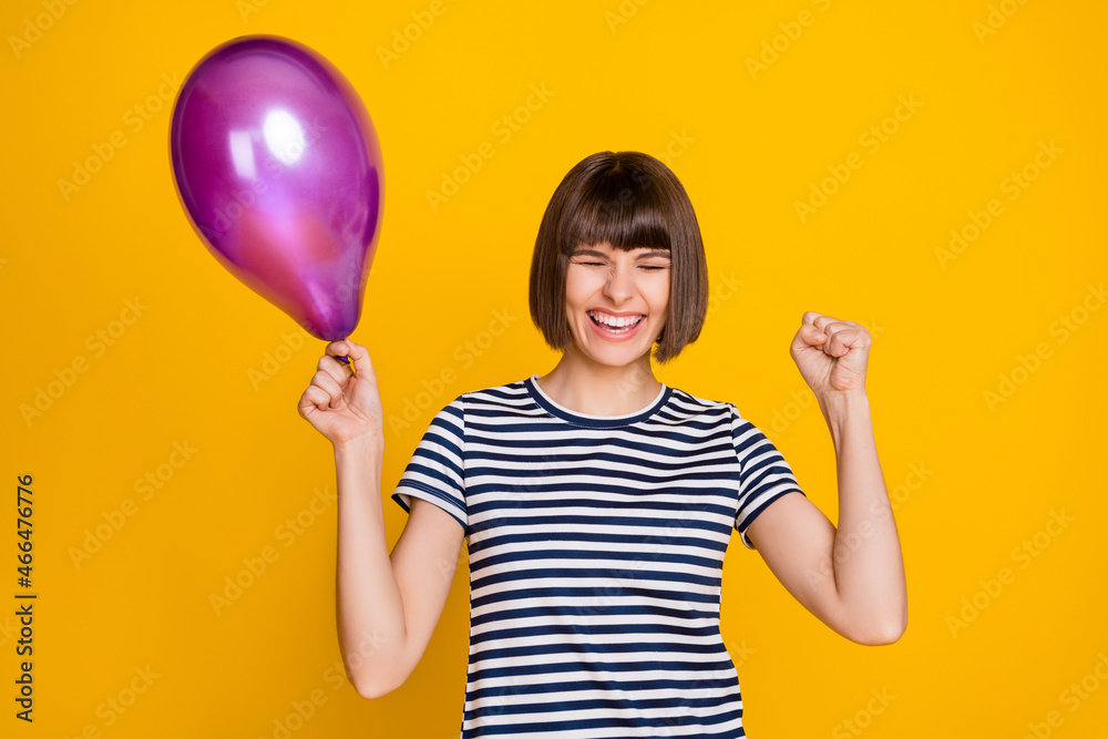 Photo of hooray brunette millennial lady hold balloon yell wear t-shirt isolated on yellow background Photo of hooray brunette millennial lady hold balloon yell wear t-shirt isolated on yellow background