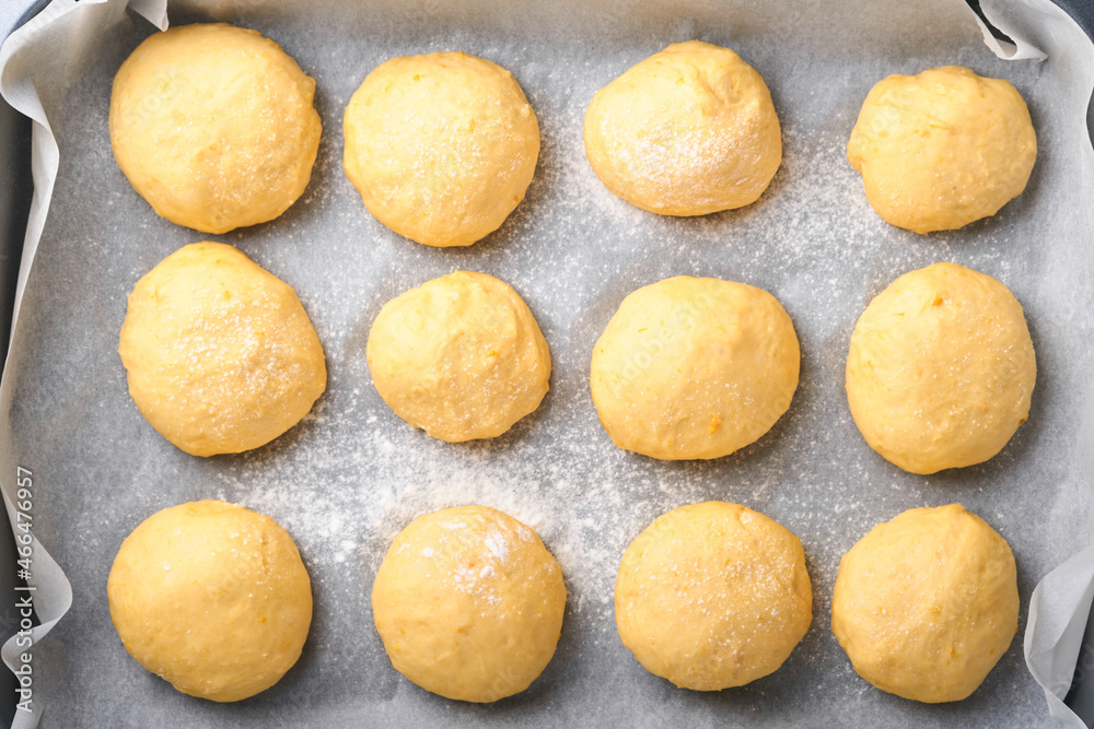 Raw yeast dough balls background in frying pan before baking. Concept home baking bread, buns or cinnabon or making dough.