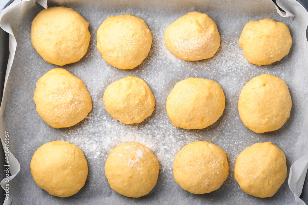 Raw yeast dough balls background in frying pan before baking. Concept home baking bread, buns or cinnabon or making dough. Raw yeast dough balls background in frying pan before baking. Concept home baking bread, buns or cinnabon or making dough.