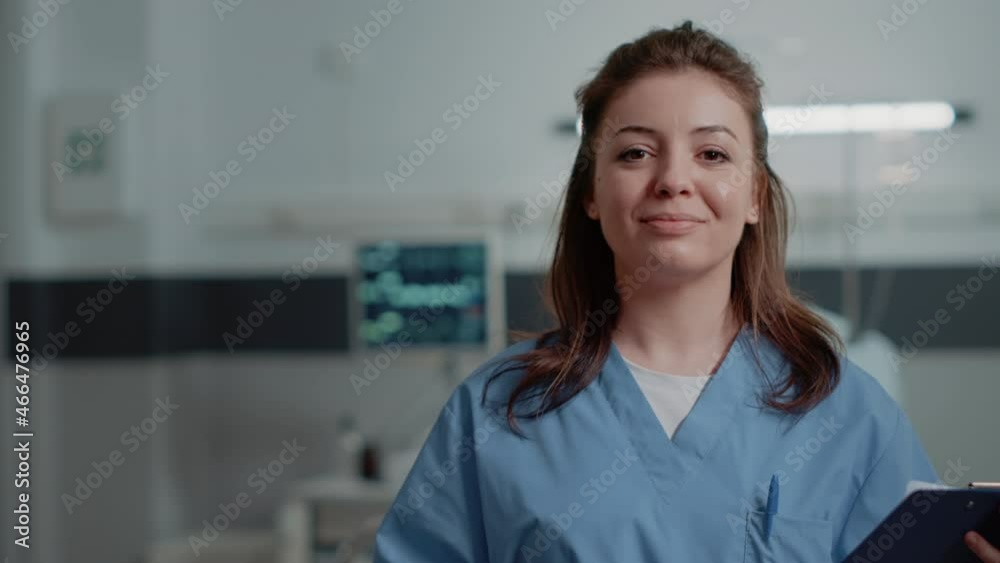 Portrait of woman nurse with medical files to give support to medic in hospital ward. Close up of medical assistant looking at camera ready to help with patient and checkup documents.