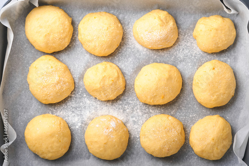 Raw yeast dough balls background in frying pan before baking. Concept home baking bread, buns or cinnabon or making dough.