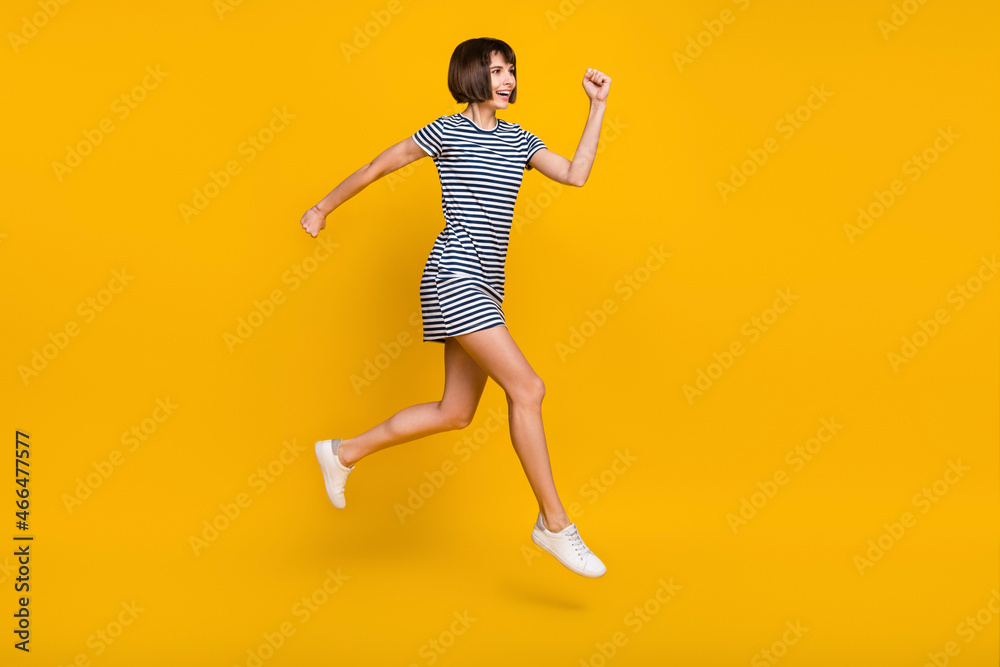 Full size photo of crazy brunette young lady run wear dress sneakers isolated on yellow background