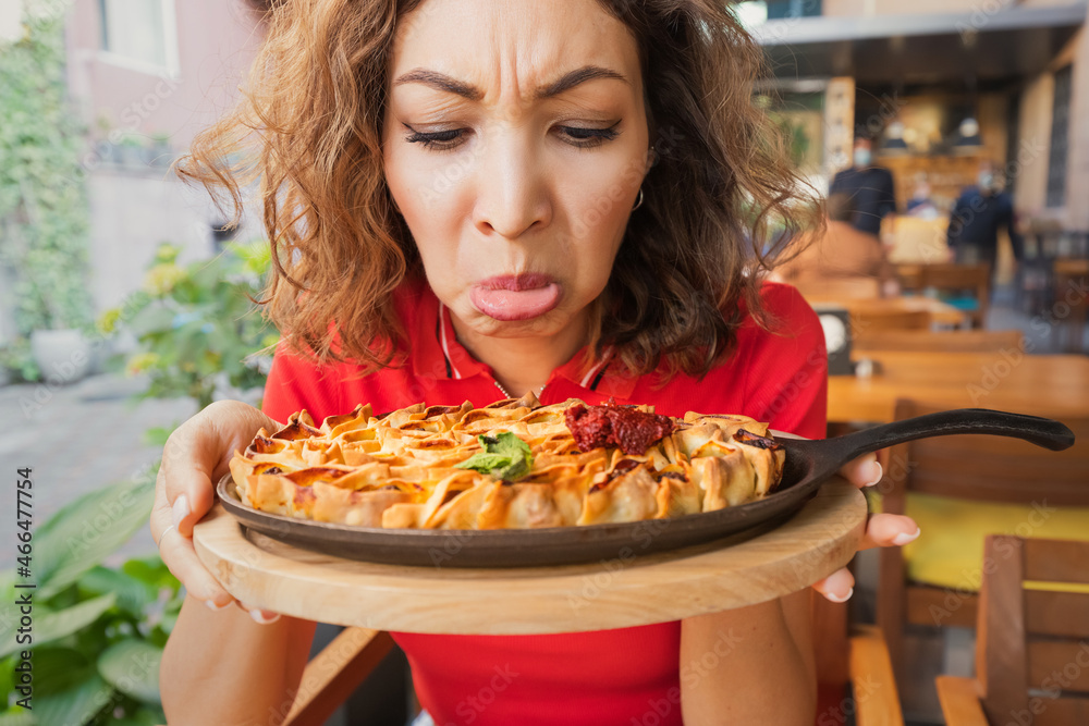 A frustrated woman in a restaurant does not feel the smell and taste of food because of the long covid effect or because of a bad cook A frustrated woman in a restaurant does not feel the smell and taste of food because of the long covid effect or because of a bad cook