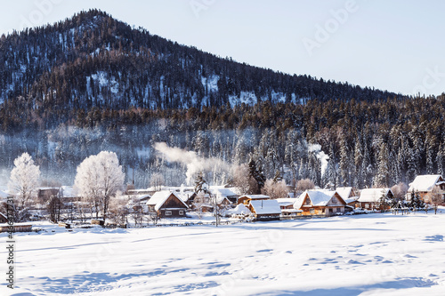 View of the winter  the village Iogach against the background of forested mountains. Altai Republic, © vesta48
