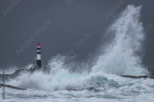 View of Kraka Lighthouse and big waves in the Atlantic Ocean, Norway photo