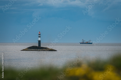 View of the Kraka Lighthouse and the ship in the Atlantic ocean, Norway photo