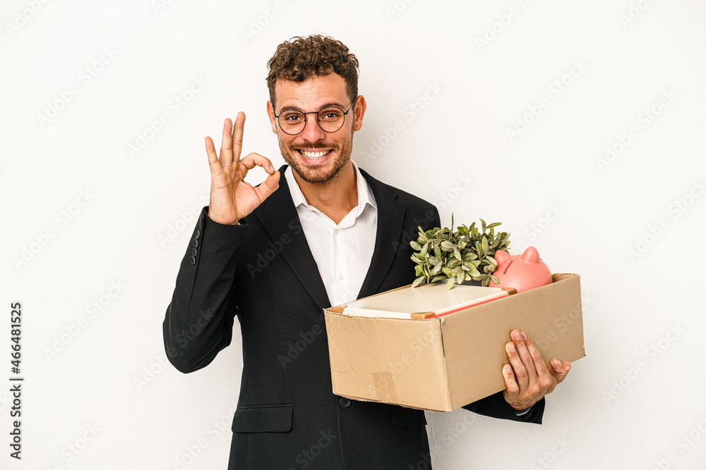 Young caucasian business man fired from his job isolated on white background cheerful and confident showing ok gesture. Young caucasian business man fired from his job isolated on white background cheerful and confident showing ok gesture.