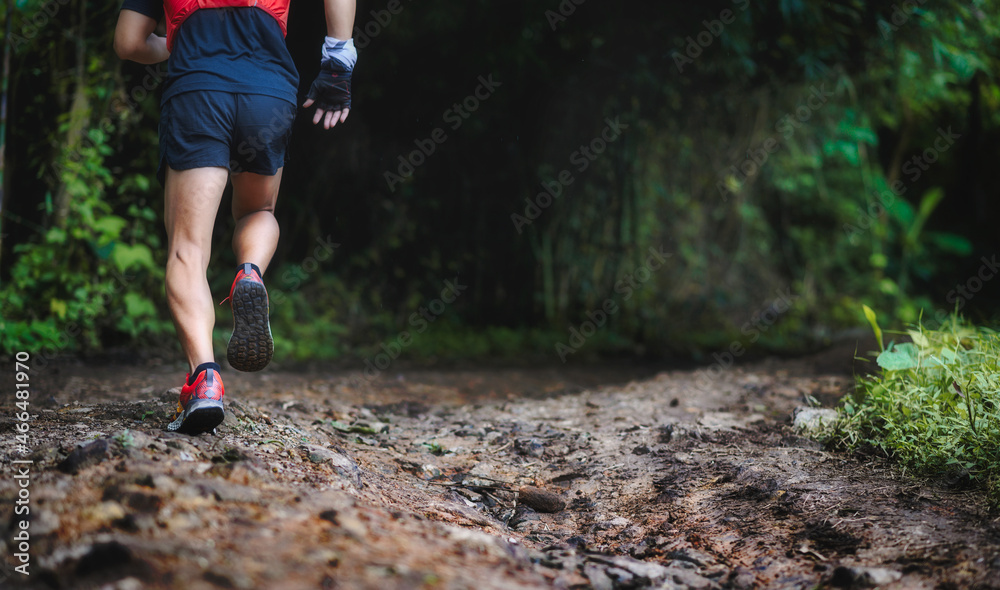 Closeup of man trail running on rocky terrain. Closeup of male feet run through rocky terrain. Focus on shoes. Closeup of man trail running on rocky terrain. Closeup of male feet run through rocky terrain. Focus on shoes.
