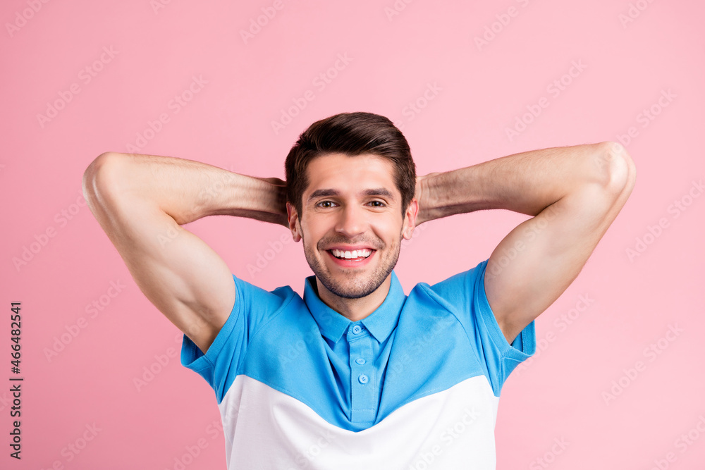 Portrait of attractive calm cheerful brunette guy resting good mood isolated over pink pastel color background