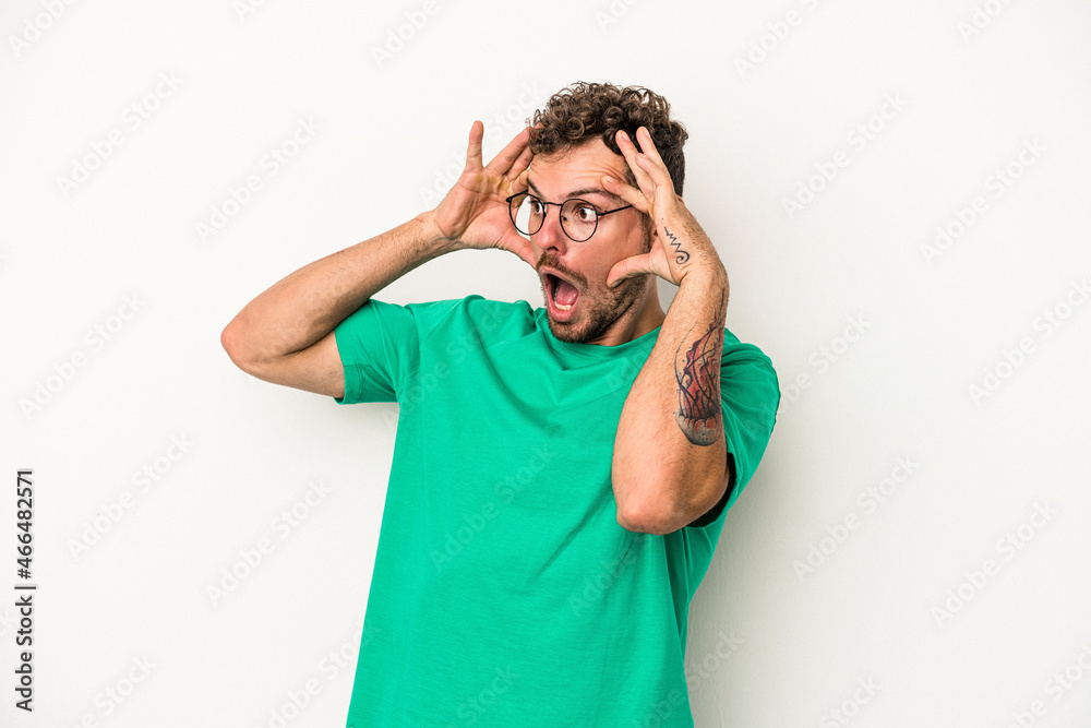 Young caucasian man isolated on white background keeping eyes opened to find a success opportunity. Young caucasian man isolated on white background keeping eyes opened to find a success opportunity.