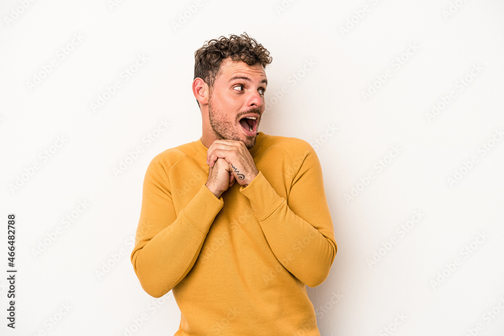 Young caucasian man isolated on white background praying for luck, amazed and opening mouth looking to front. Young caucasian man isolated on white background praying for luck, amazed and opening mouth looking to front.