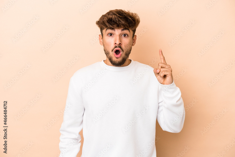 Young arab man isolated on beige background having an idea, inspiration concept. Young arab man isolated on beige background having an idea, inspiration concept.