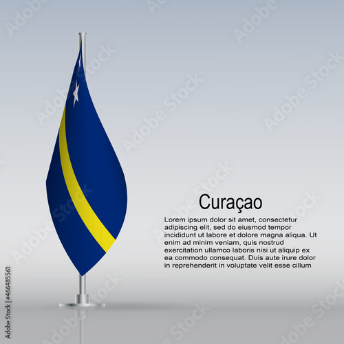 Flag of Curacao hanging on a flagpole stands on the table photo