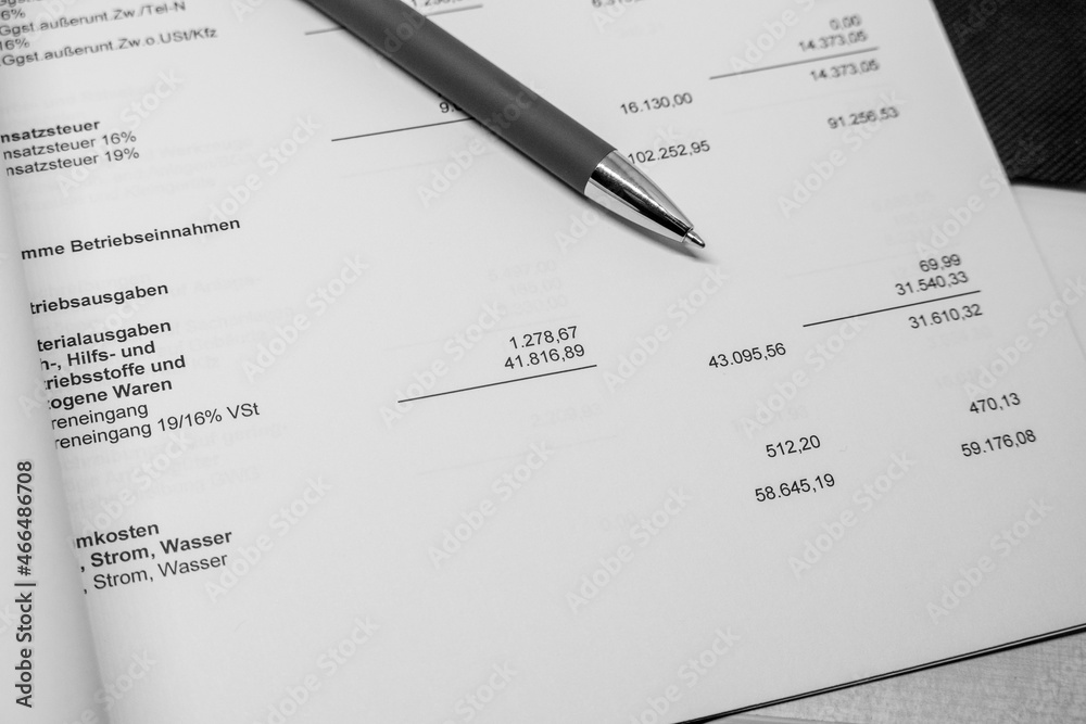 ballpoint pen and a calculator lie on a financial evaluation ballpoint pen and a calculator lie on a financial evaluation