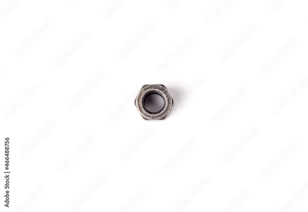 One macro metallic screw nut isolated on white background. Female screw nut with copy space. Heavy hex nut. Fastener top view One macro metallic screw nut isolated on white background. Female screw nut with copy space. Heavy hex nut. Fastener top view