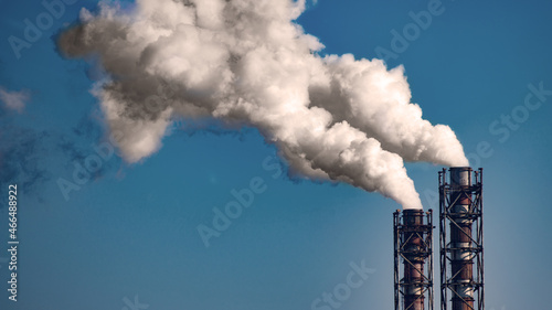 Obraz na płótnie Smoke stack of coal power plant on blue sky background. Place for text w salonie