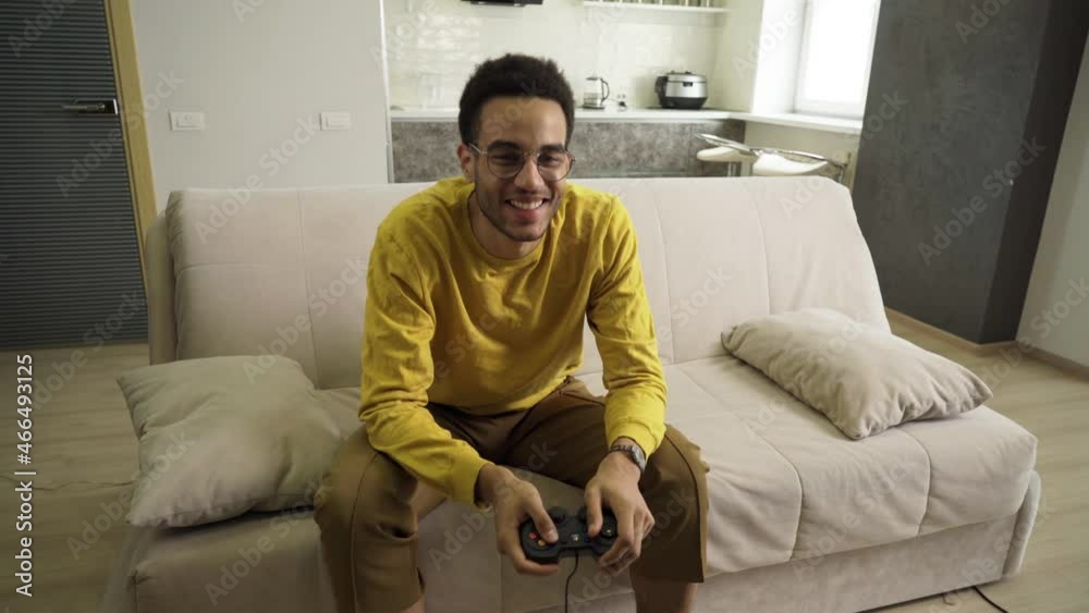 A young African man plays a console emotionally and loses miserably A young African man plays a console emotionally and loses miserably