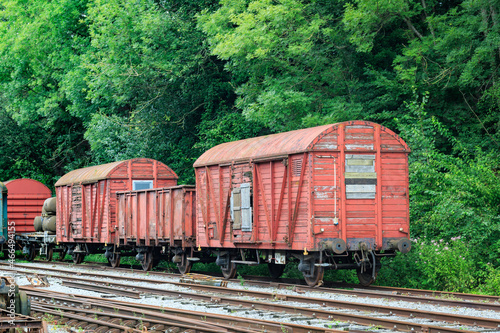 old abandoned damaged and weatherd wooden red train cars