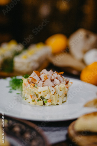 festive New Year's table with delicious dishes in the Soviet style, olives, baked meat, lard, champagne photo