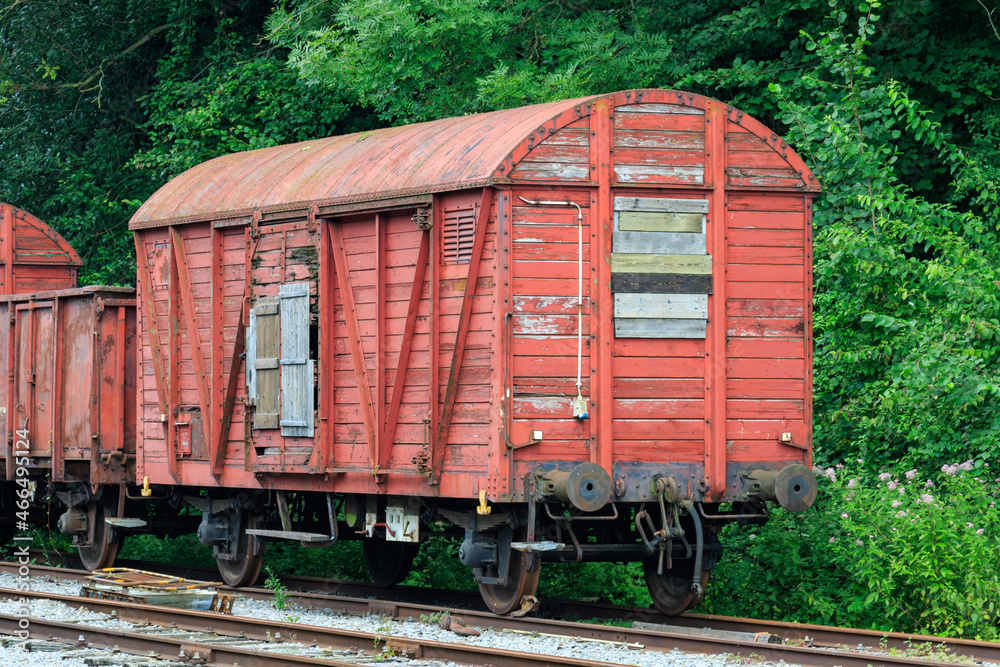 old abandoned damaged and weatherd wooden red train cars