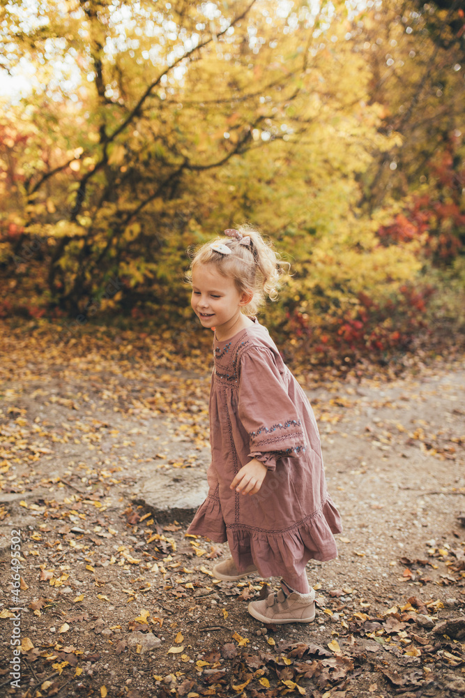 Cute little girl in an autumn forest.